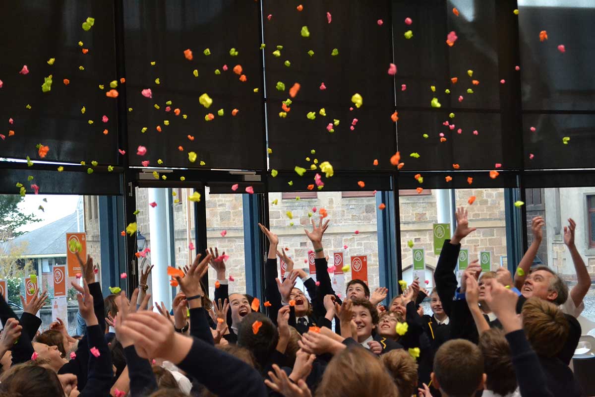 Image of students throwing paper in the air